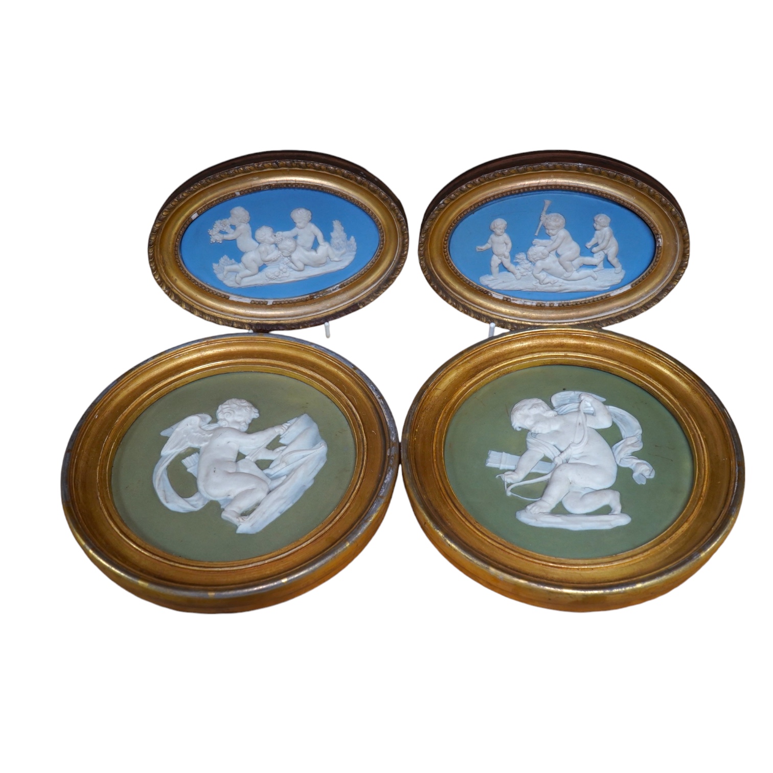 Two pairs of jasperware plaques, probably Wedgwood, in gilt frames, largest 19cm in diameter. Condition - fair to good